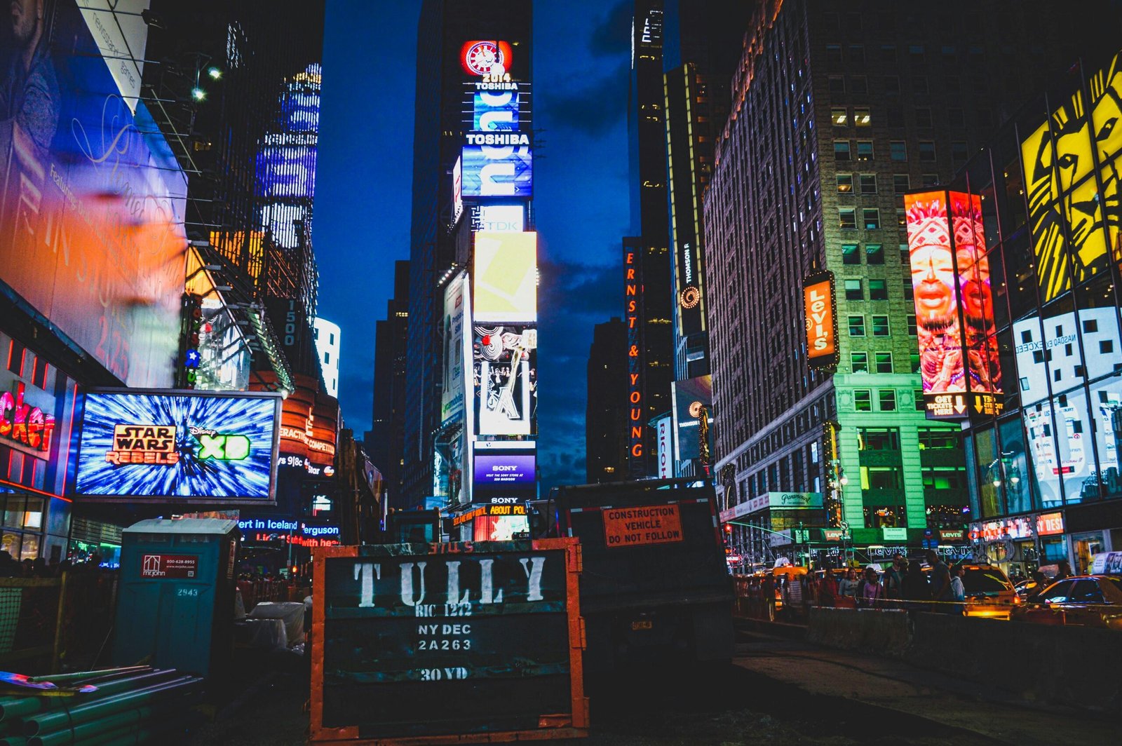 An iconic view of Times Square, New York City, illuminated with colorful lights and billboards at night.